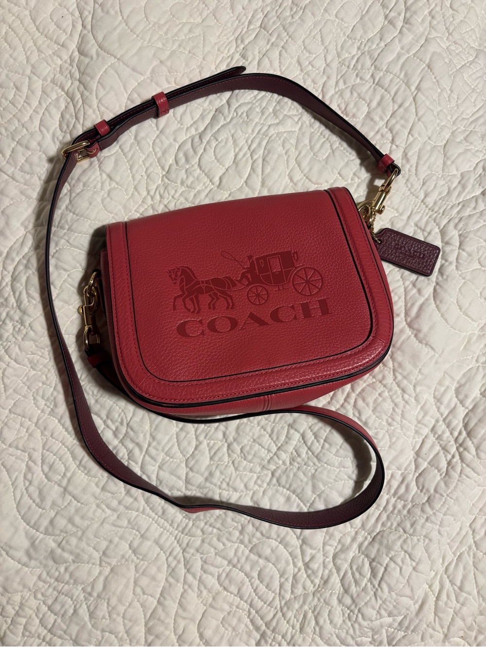 Coach Horse and Carriage Saddle Bag in a poppy pink pebble leather